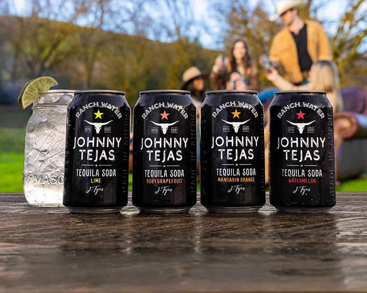 4 cans of Johnny Tejas tequila soda on a wooden table